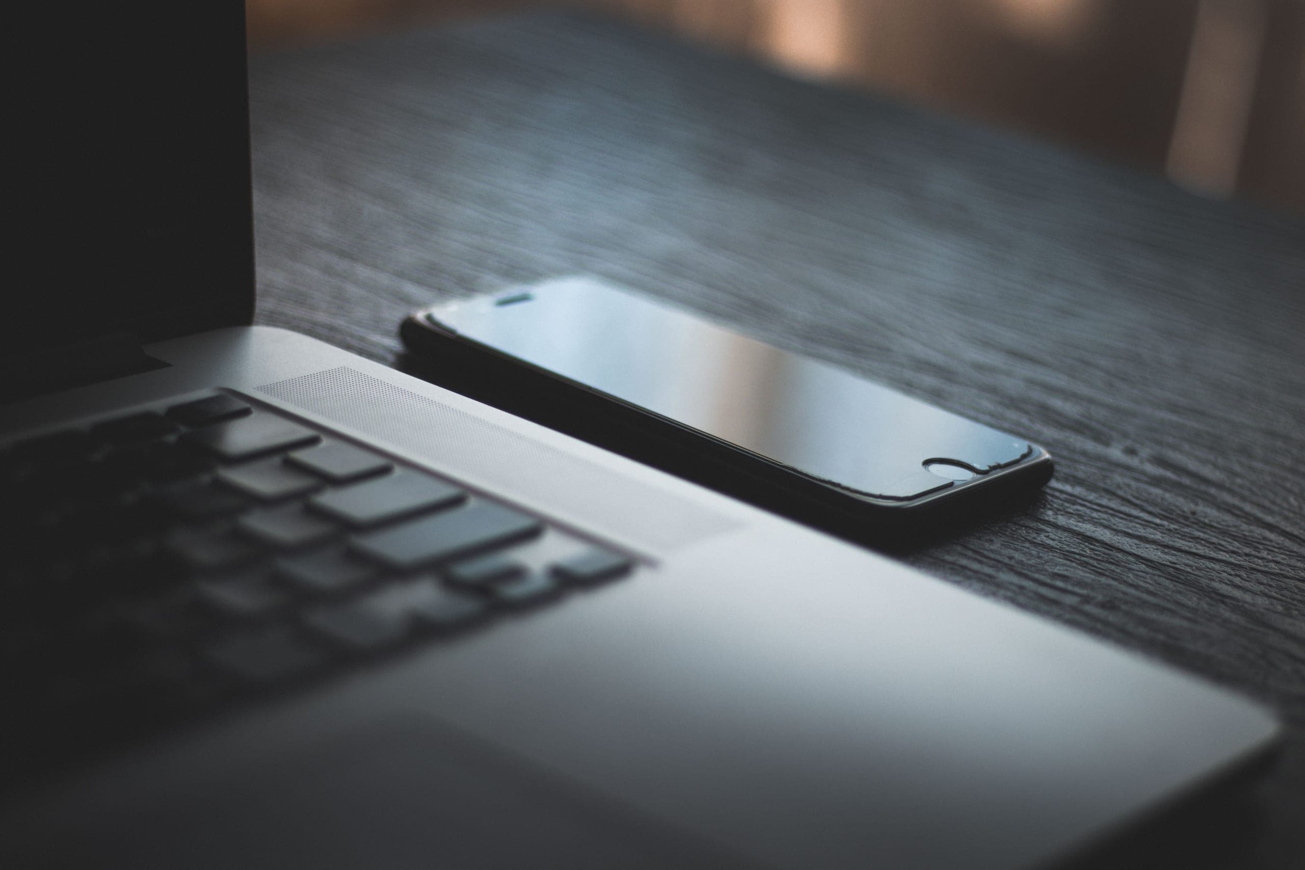 Laptop and smartphone side by side on a desk