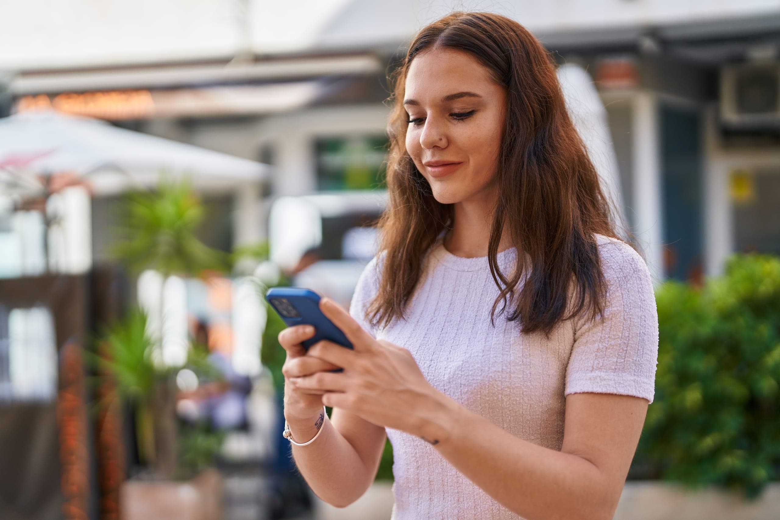 Woman texting on her phone outdoors