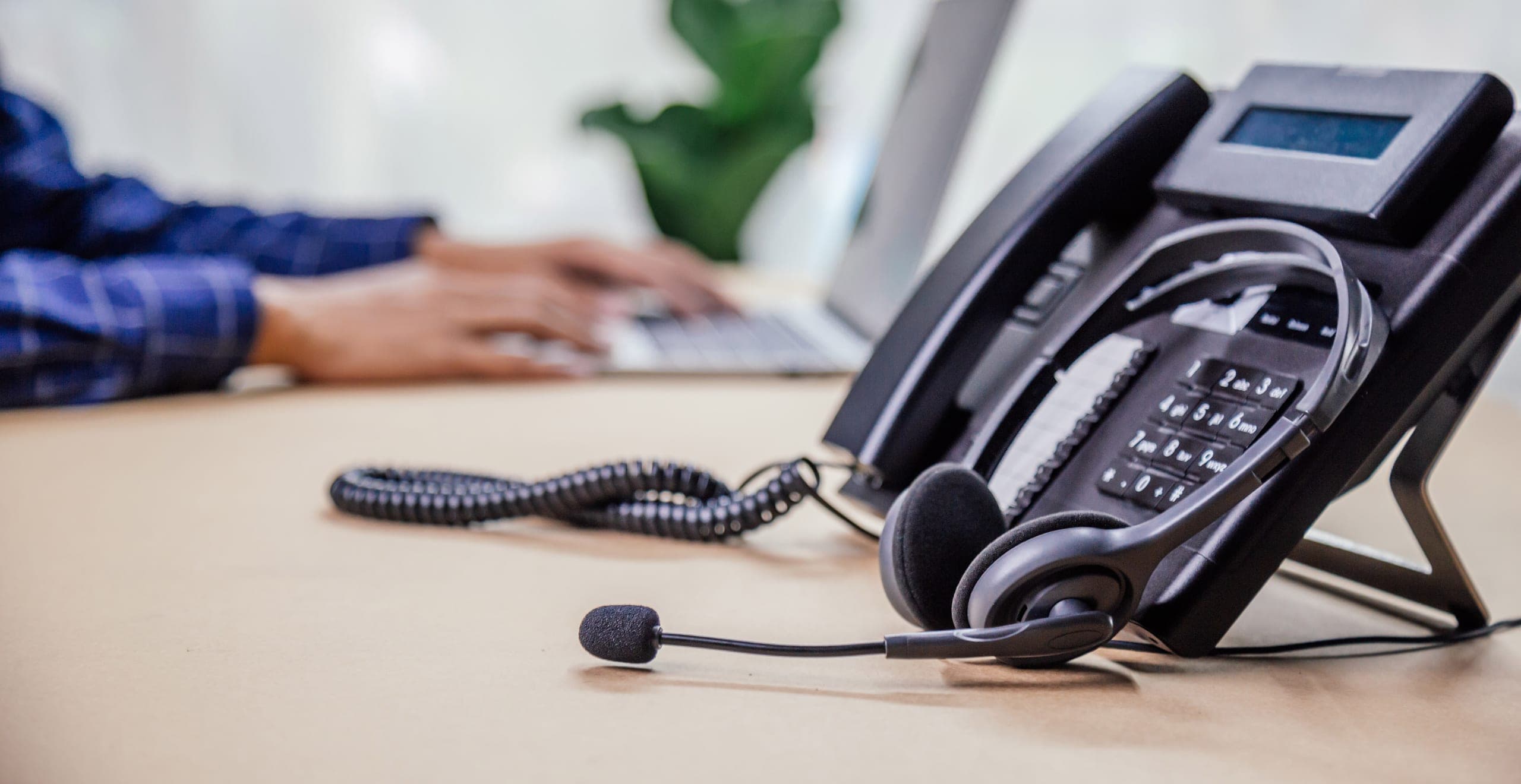 Desk phone and headset on an office desk