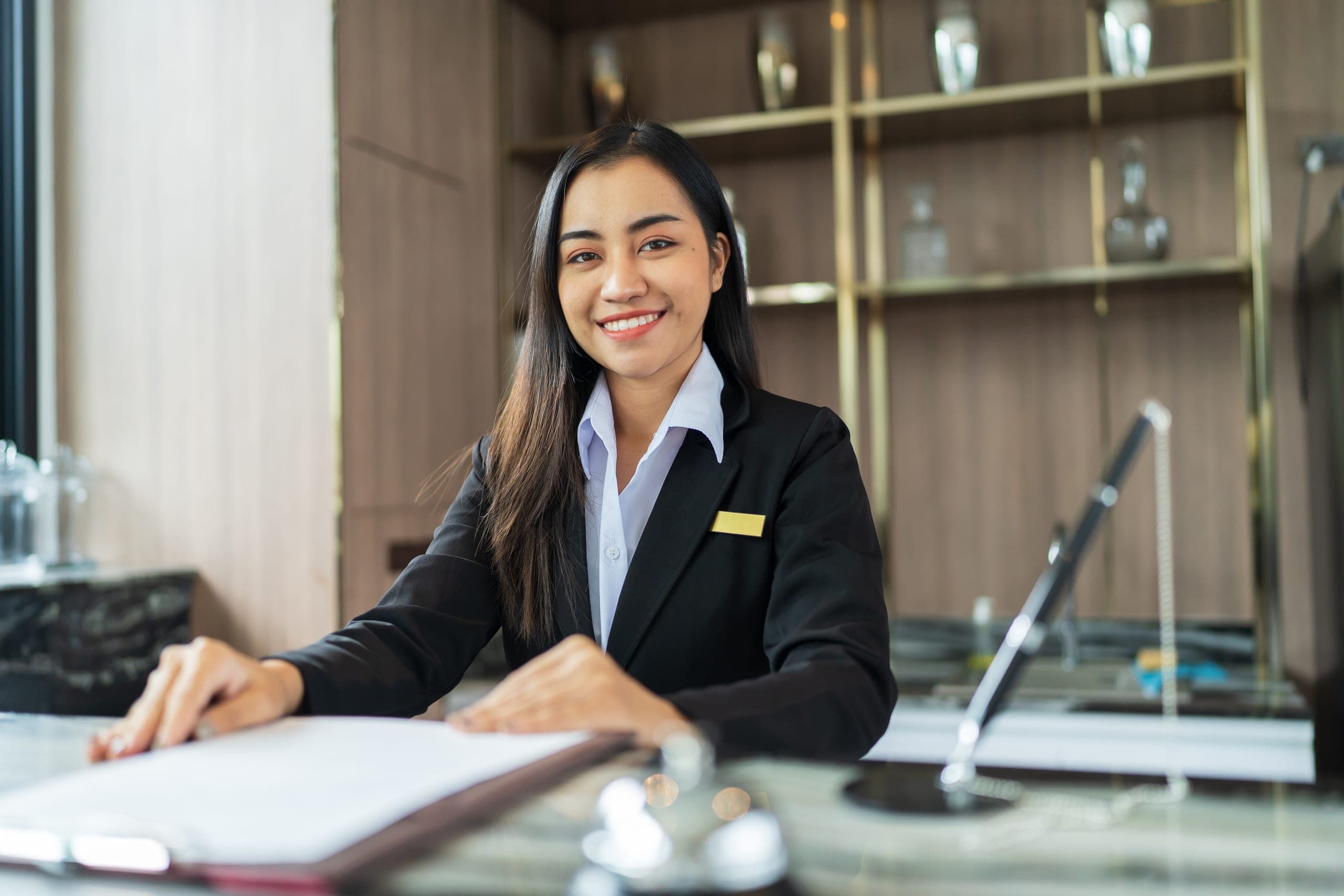 Hotel receptionist in uniform at the front desk